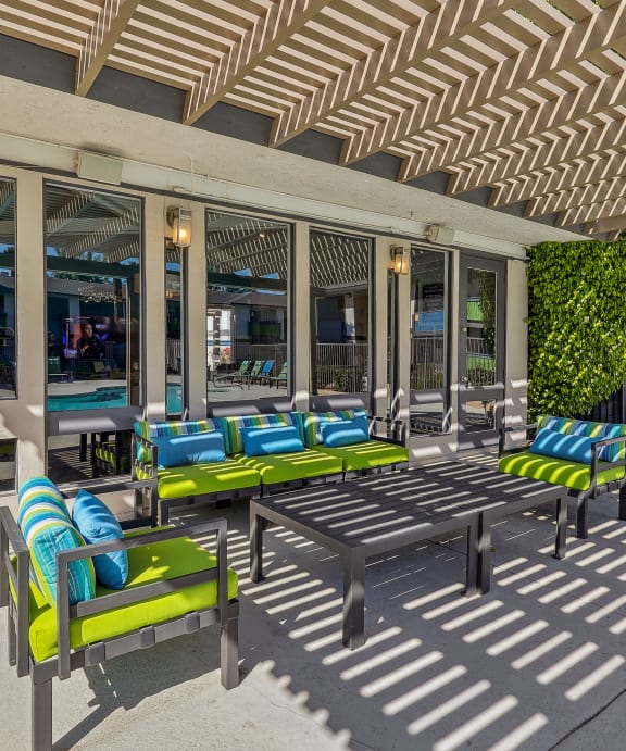 our apartments have a large swimming pool and a patio with chairs